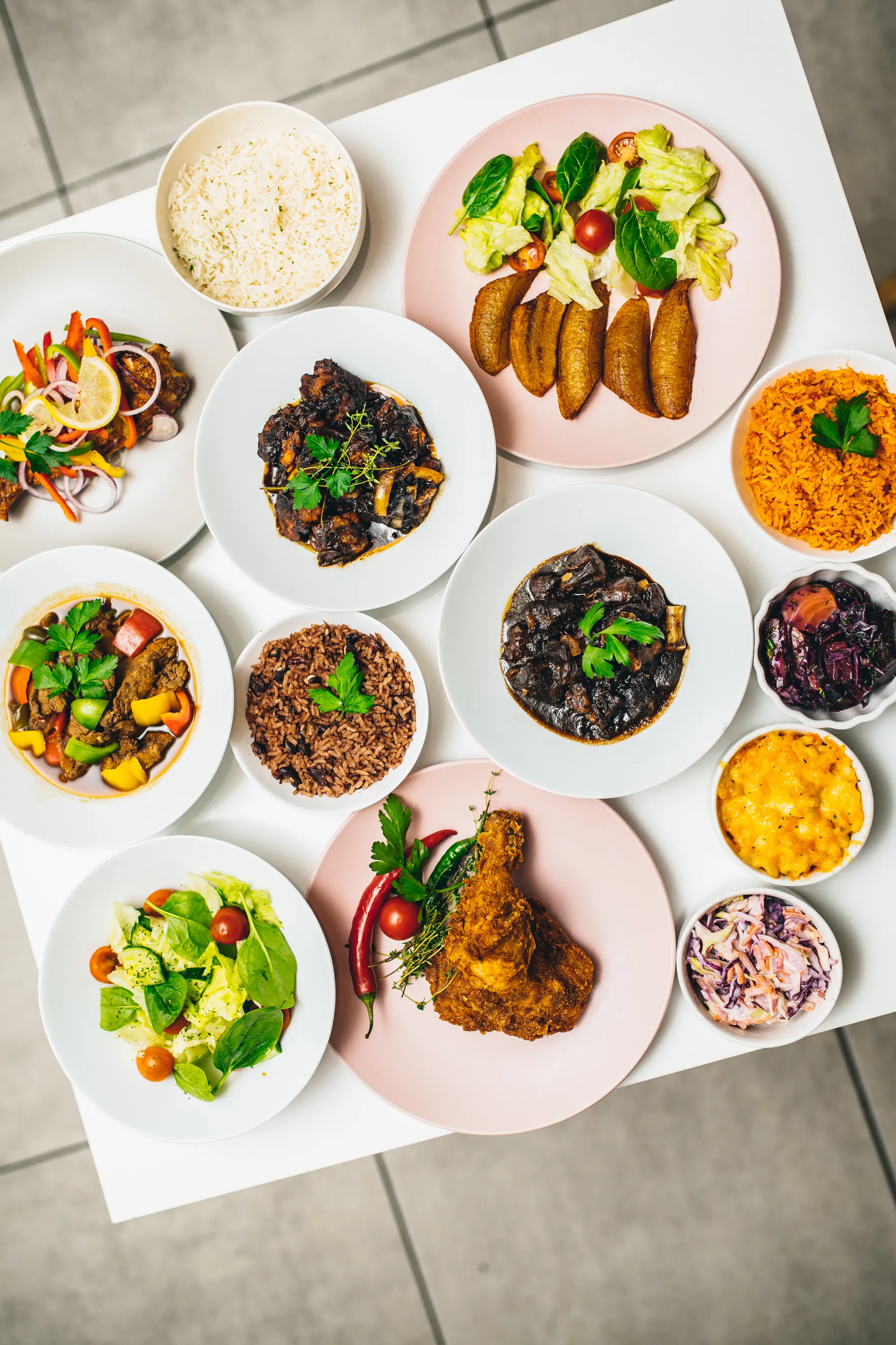 Afro-Caribbean buffet catering in London - jollof rice, rice and peas, fried plantain, oxtail, brown stew chicken, fried chicken, mac and cheese and coleslaw