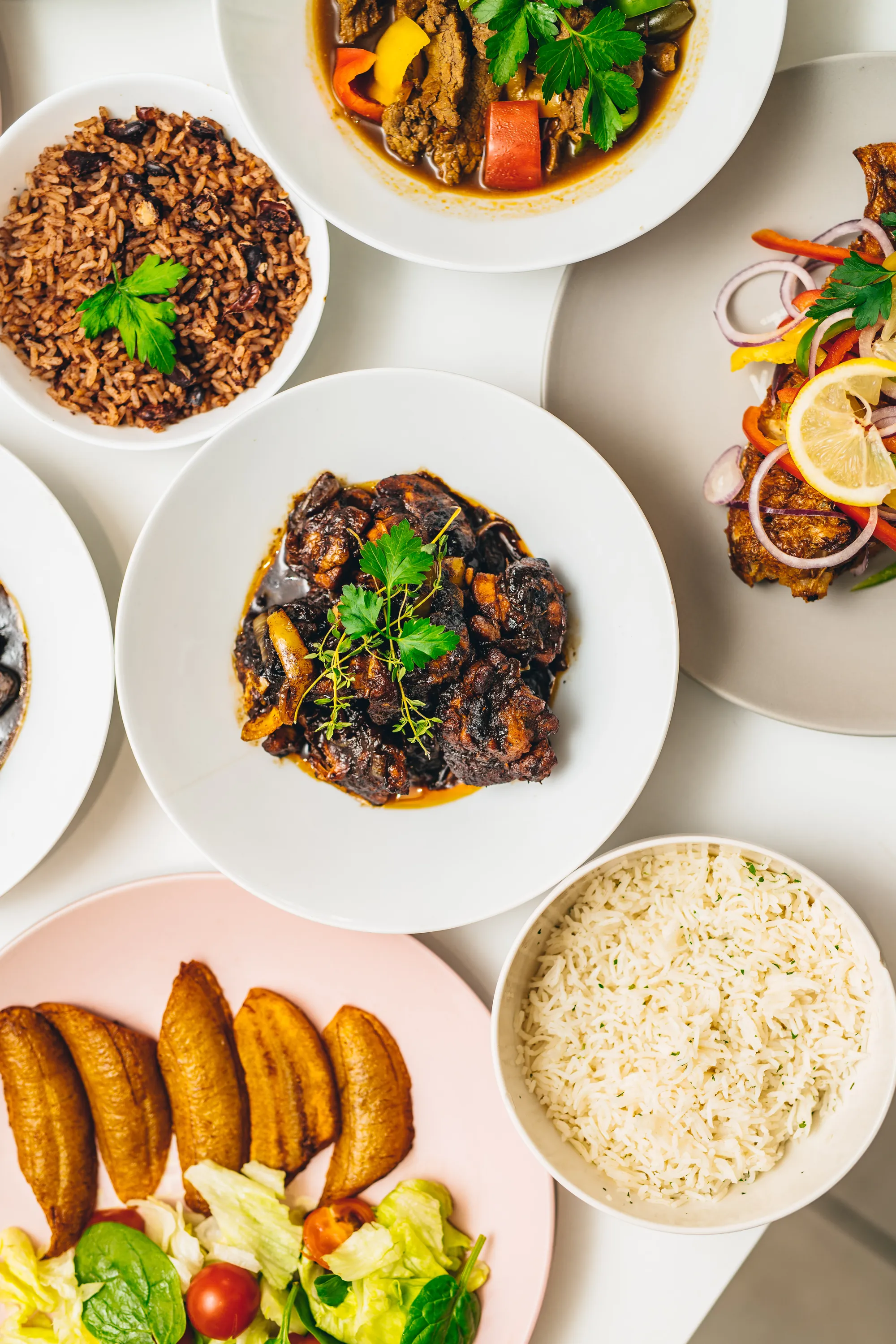 Caribbean rice and peas, brown stew chicken, escovitch fish and fried plantain prepared by Tobis Private Catering London